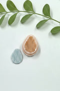 Pear striped polymer clay cutter by Petal & Posy, showcasing a detailed pear-shaped design with colorful striped pattern.