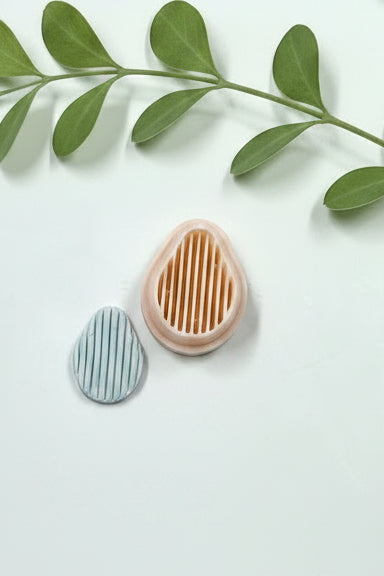 Pear striped polymer clay cutter by Petal & Posy, showcasing a detailed pear-shaped design with colorful striped pattern.