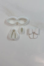 Petal & Posy petite bow polymer clay cutter set with various bow shapes for crafting and jewelry making.