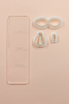 Petal & Posy Petite Bow Polymer Clay Cutter Set with various bow-shaped cutters on a white background.