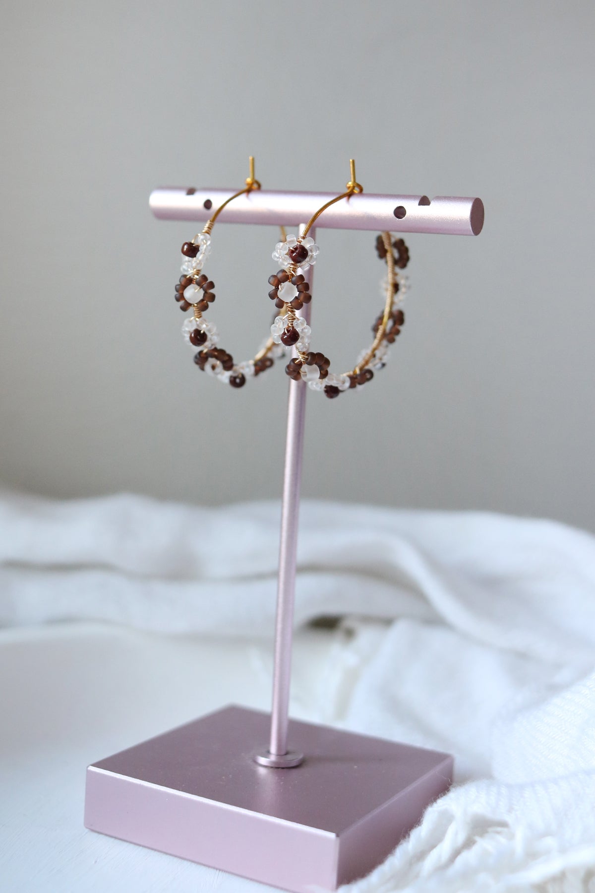 Petal & Posy tortoise Daisy Chain hand-beaded hoop earrings with floral detail, showcasing intricate beadwork and natural tortoise pattern.