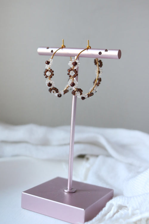 Petal & Posy tortoise Daisy Chain hand-beaded hoop earrings with floral detail, showcasing intricate beadwork and natural tortoise pattern.