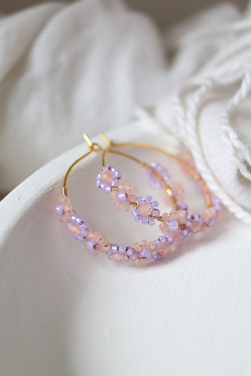 Lilac beaded hoop earrings with daisy chain design by Petal & Posy, featuring delicate hand-beaded floral details.