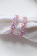 Lilac beaded hoop earrings with daisy chain design from Petal & Posy, featuring intricate hand-beaded details and gold-tone hoops.
