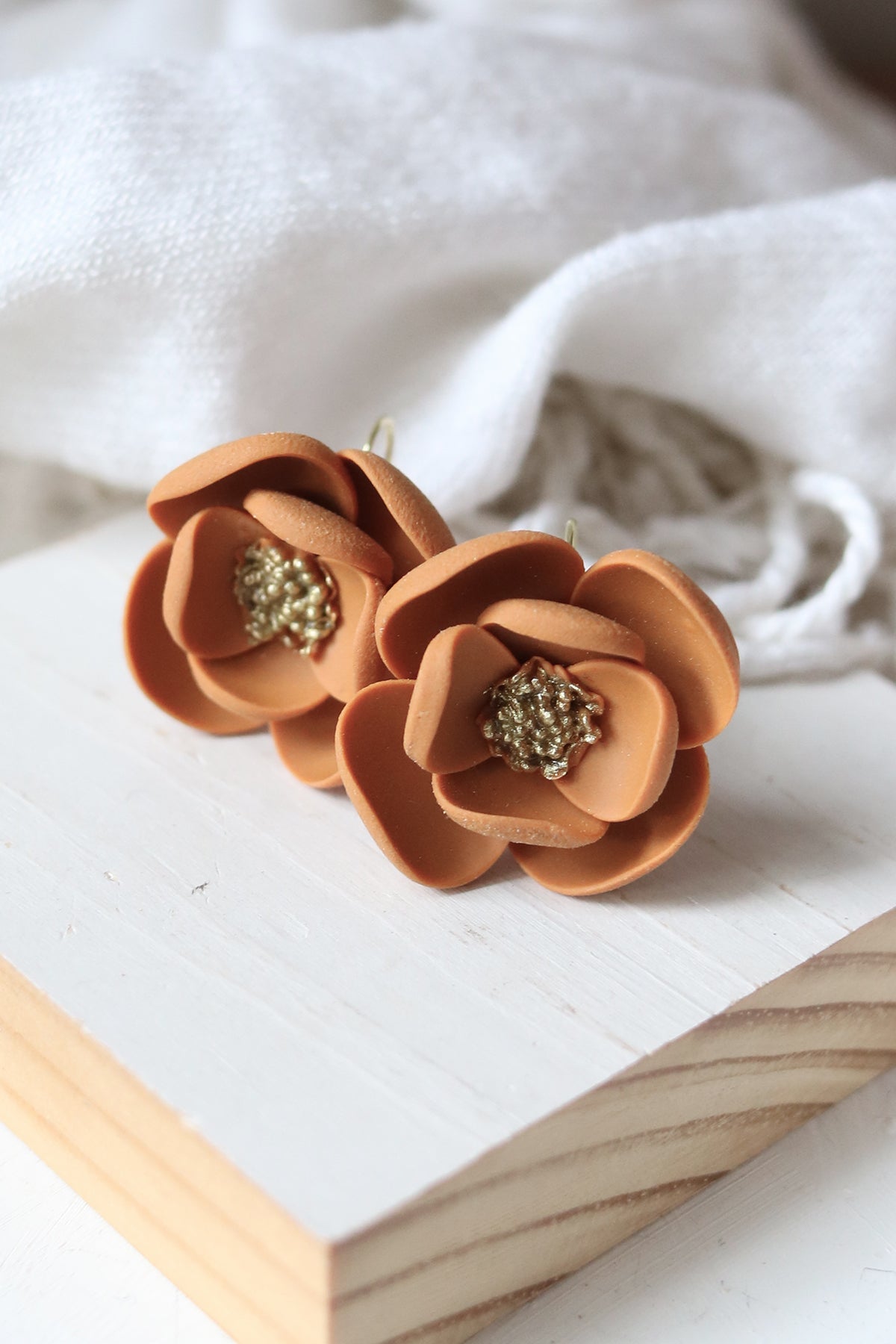 Petal & Posy Eventide Bloom Hook Earrings in ochre, featuring delicate floral design and gold-tone hooks.