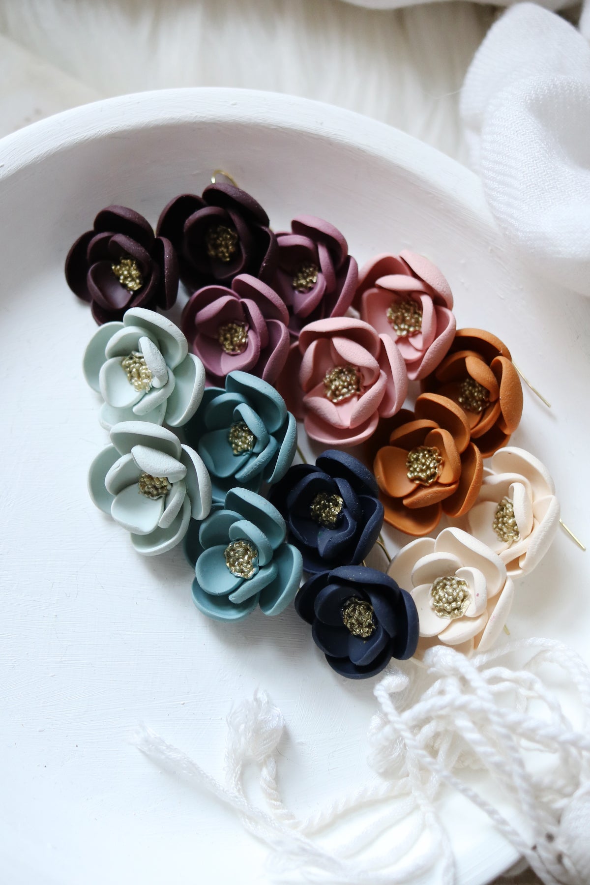 Petal & Posy Eventide Bloom hook earrings in vibrant colors, featuring delicate floral design and lightweight metal hooks.