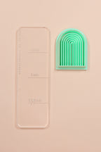 Long rainbow embossing arch polymer clay cutter by Petal & Posy, showcasing a colorful, detailed clay shaping tool.