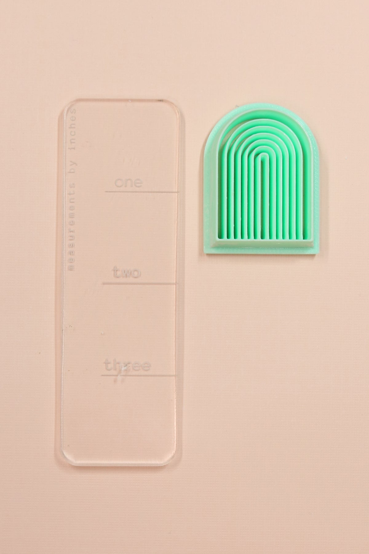 Long rainbow embossing arch polymer clay cutter by Petal & Posy, showcasing a colorful, detailed clay shaping tool.