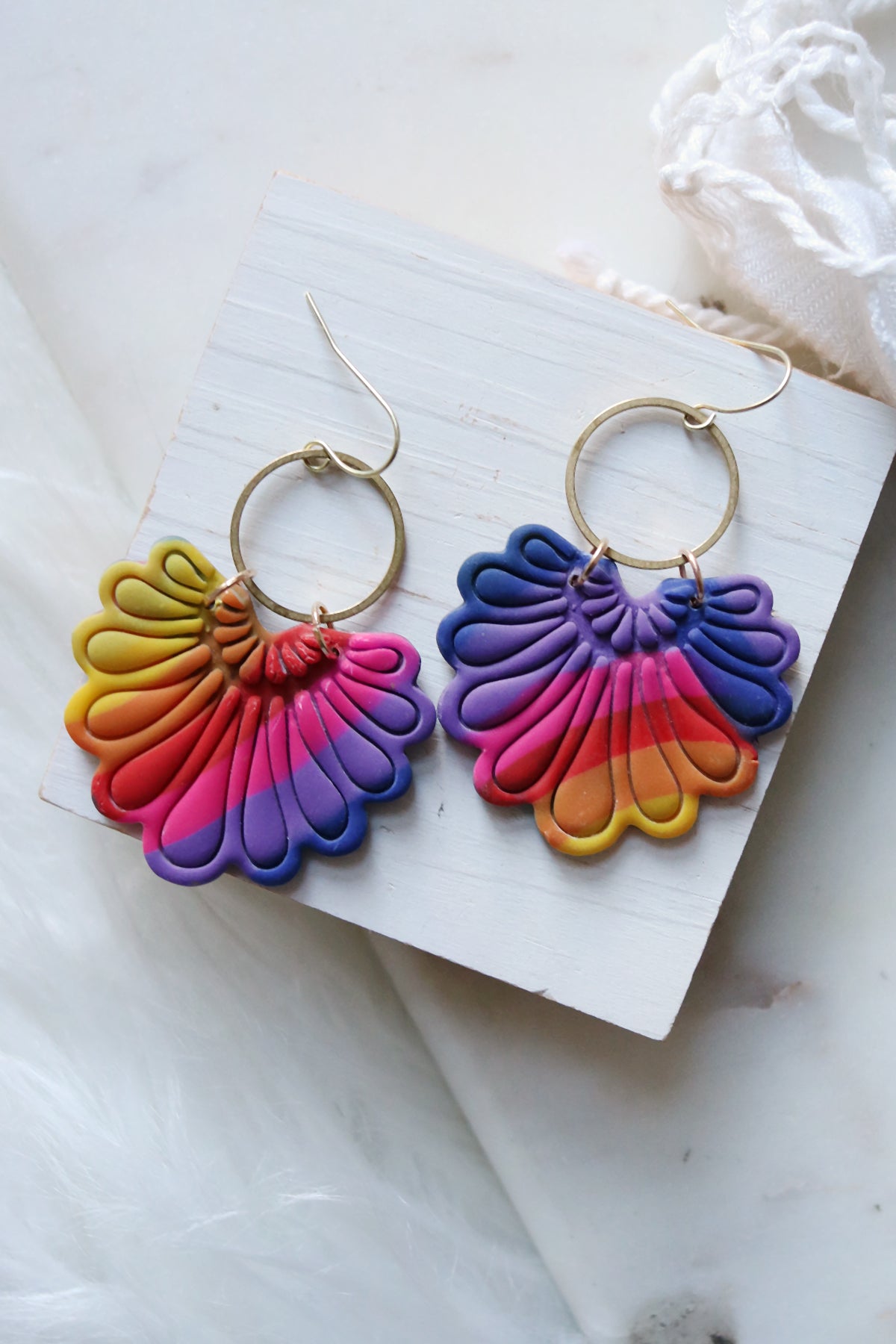 Rainbow polymer clay hook earrings with prism plume design by Petal & Posy, showcasing colorful, textured handcrafted jewelry.