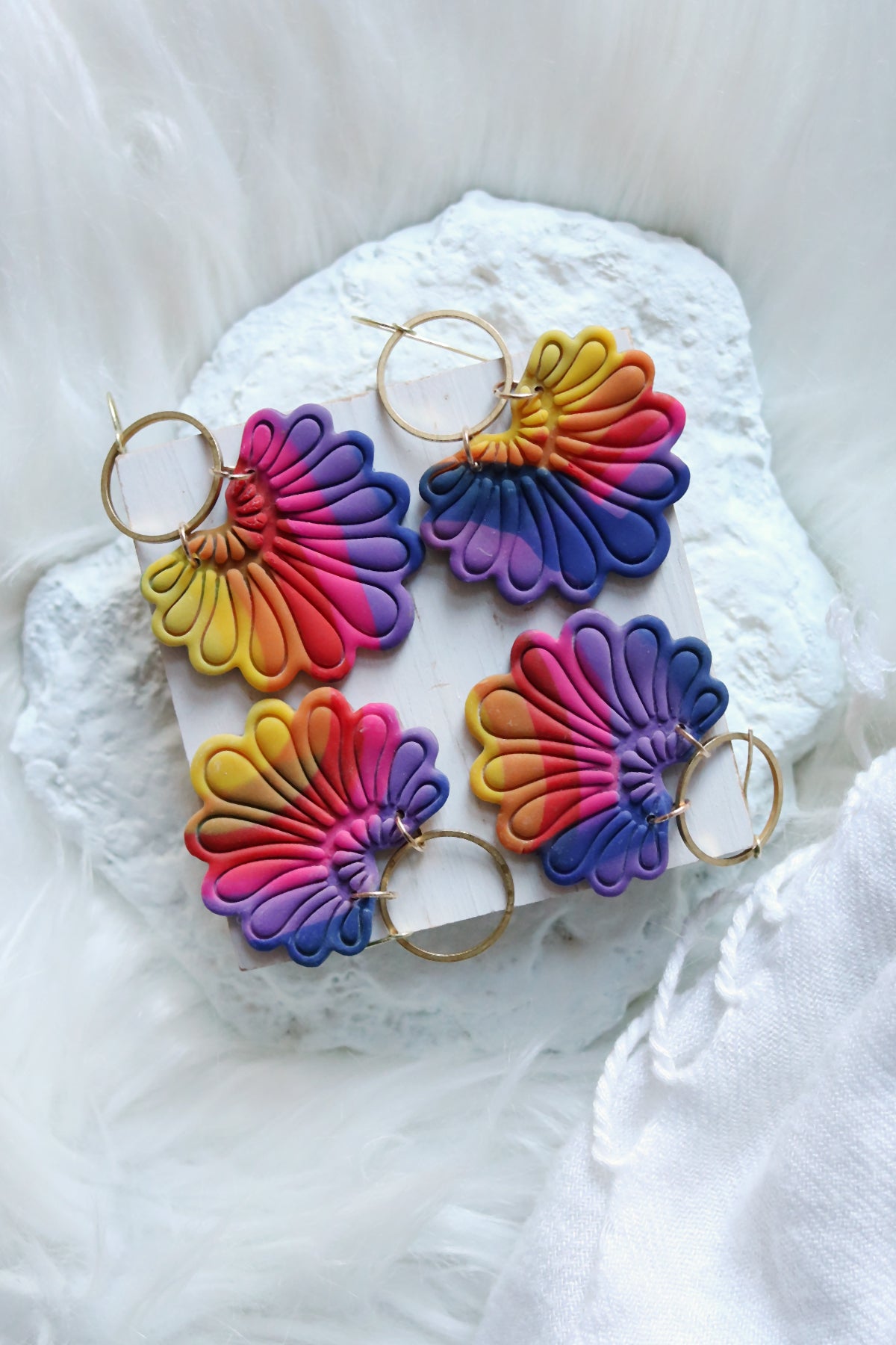 Rainbow polymer clay hook earrings with prism plume design by Petal & Posy, featuring vibrant colors and unique handcrafted details.