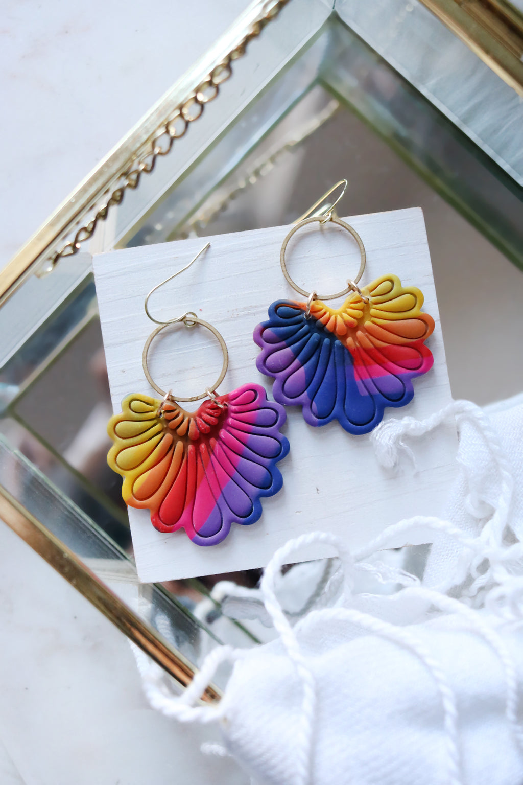 Rainbow polymer clay hook earrings with prism plume design by Petal & Posy, featuring vibrant, colorful artistry.