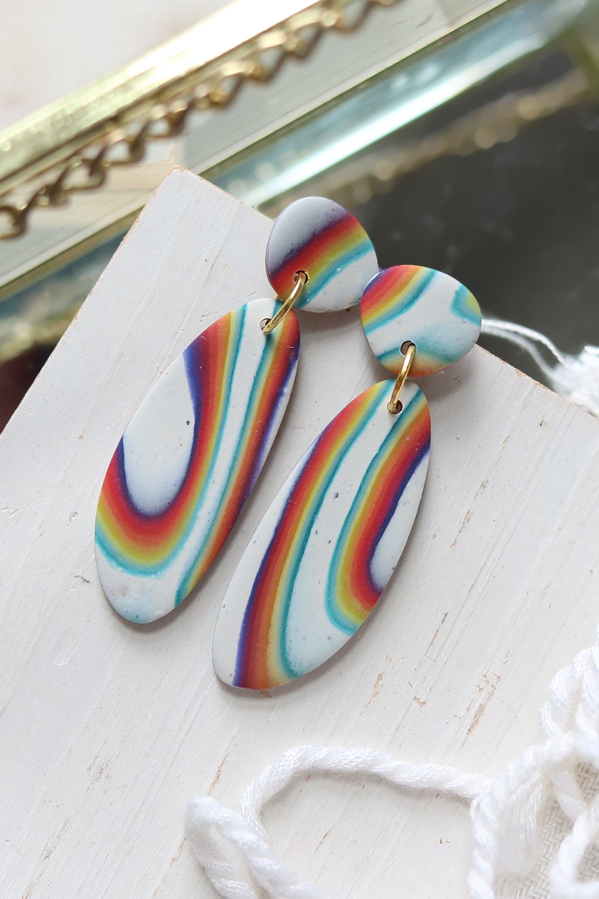 Rainbow Road polymer clay dangle earrings featuring vibrant rainbow-colored patterns, handmade by Petal & Posy.