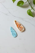 Petal & Posy swirling teardrop polymer clay cutter with intricate swirl design for crafting jewelry and embellishments.
