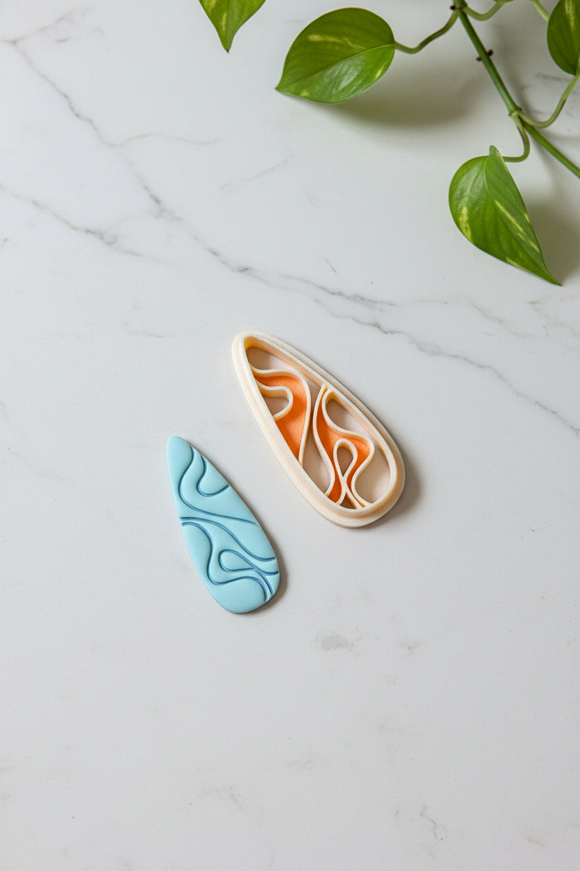 Petal & Posy swirling teardrop polymer clay cutter with intricate swirl design for crafting jewelry and embellishments.